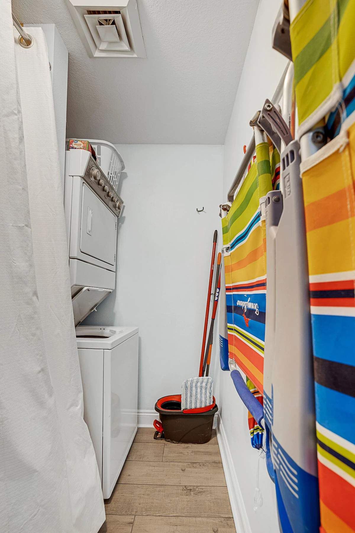 laundry room with beach chairs and umbrellas